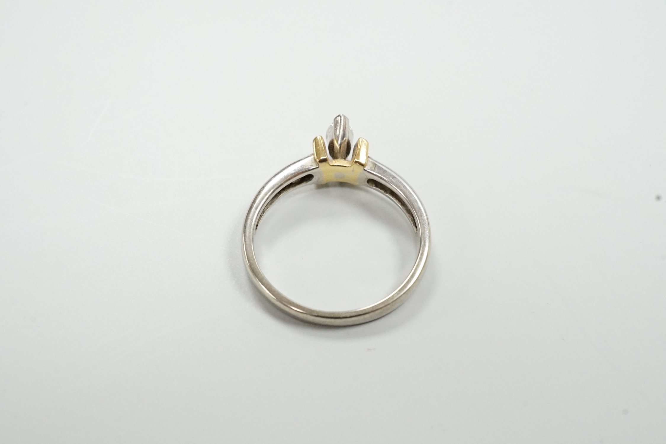 A modern two colour 18ct and solitaire marquise cut diamond set ring, size M/N, gross weight 3.6 grams.